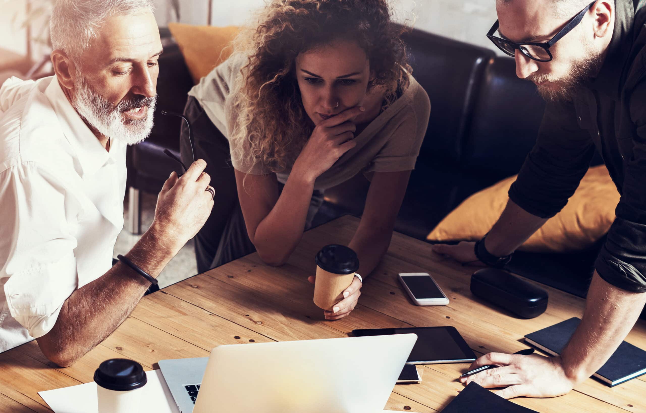 Closeup concept of business people brainstorming.Bearded man talking with account director and creative manager to finding great work solution.Horizontal, blurred background.